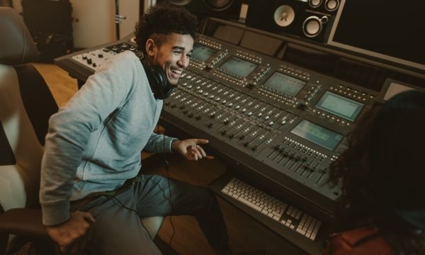happy young sound producer sitting at studio happy young sound producer sitting at studio